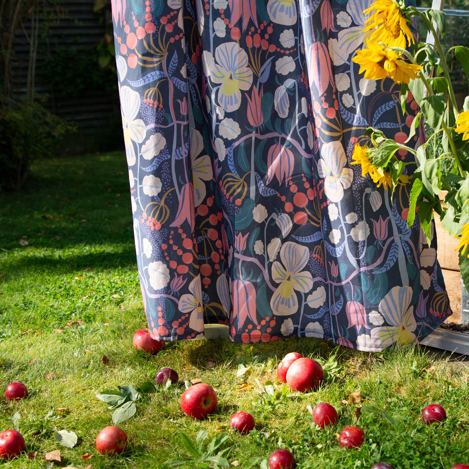 Blommig mönstrad gardin ute i trädgården